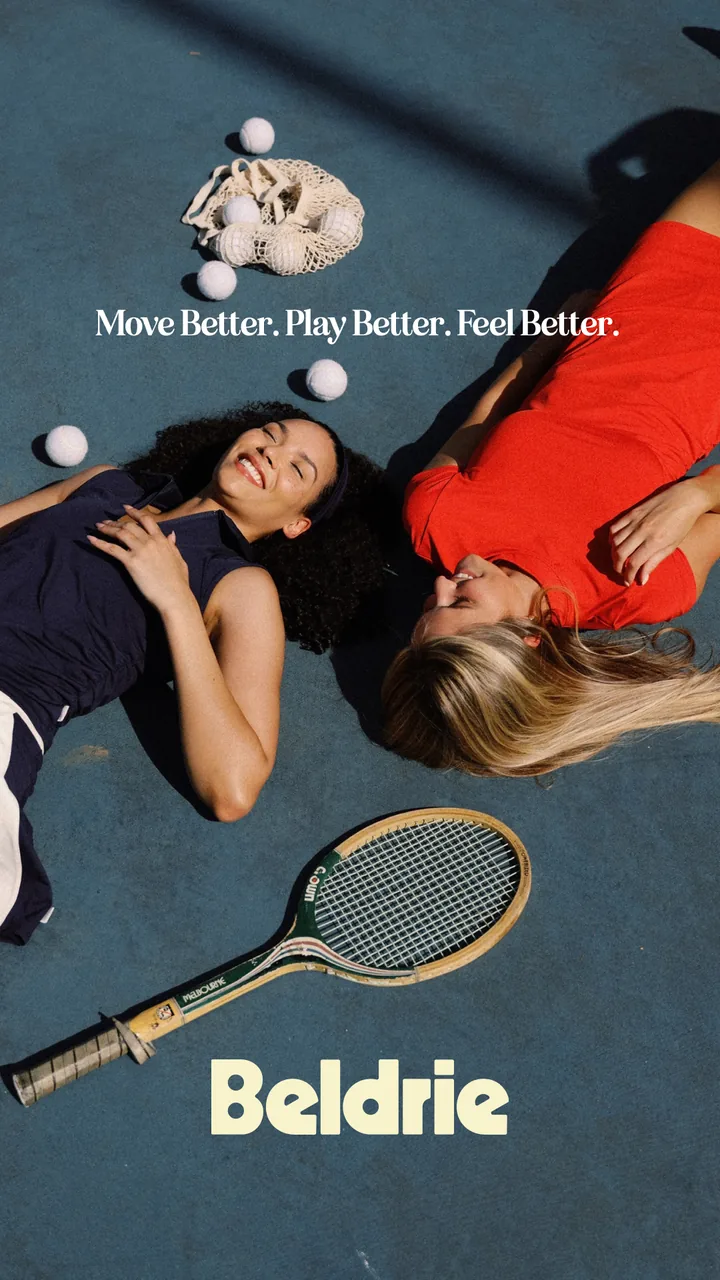 Two Beldrie players lying on a court beside wooden rackets